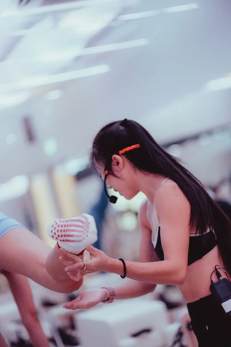 An instructor helping a client on the reformer