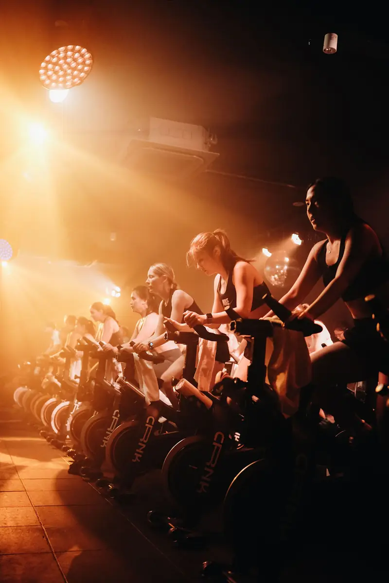 Riders lit by warm orange stage light