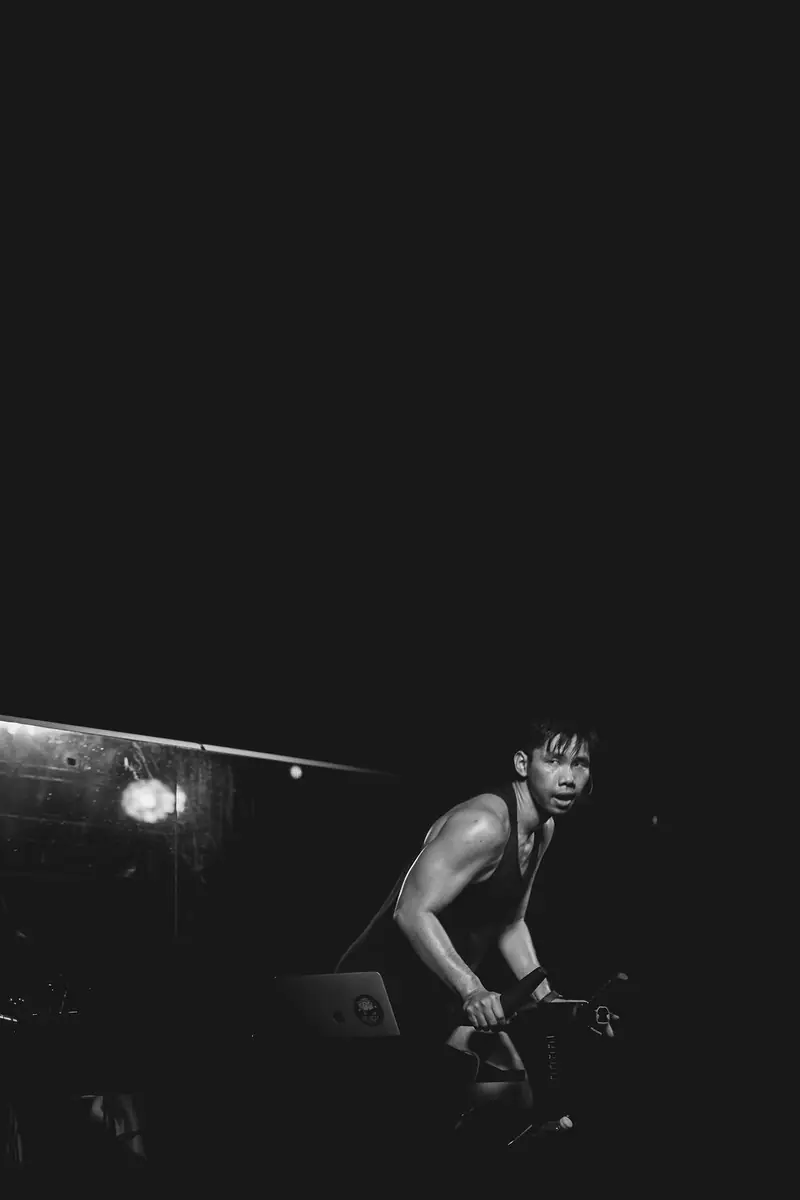 Black and white photo of a lone rider in the dark