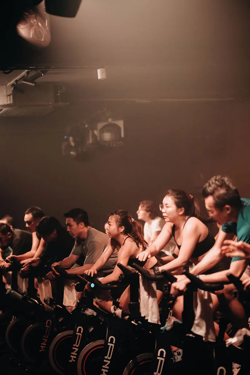 Riders on CRNK bikes in warm light, smiling mid-class