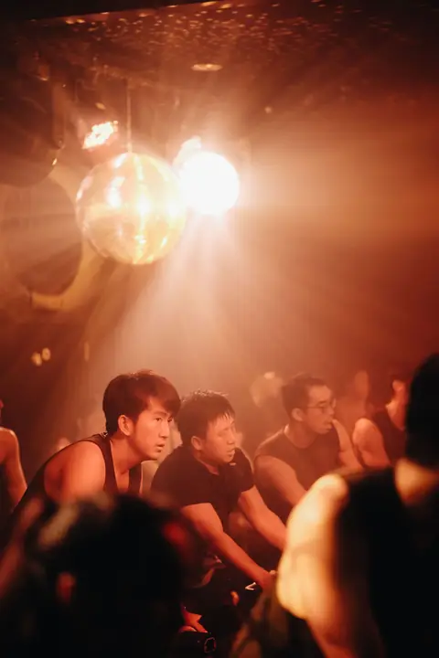 A disco ball and warm light over riders