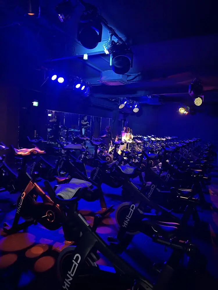 Rows of CRNK bikes under blue stage lights at CRNK New Bahru